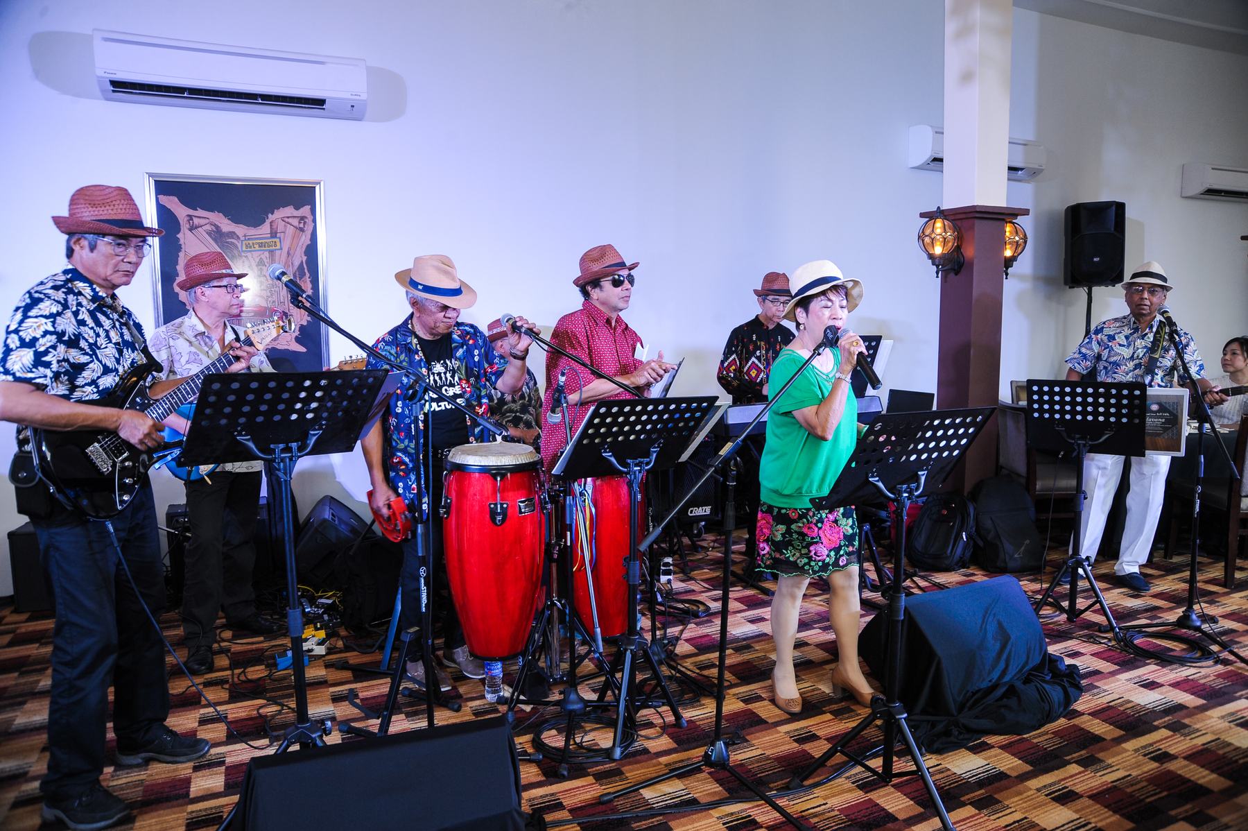 Live band playing to a crowded rooftop hall