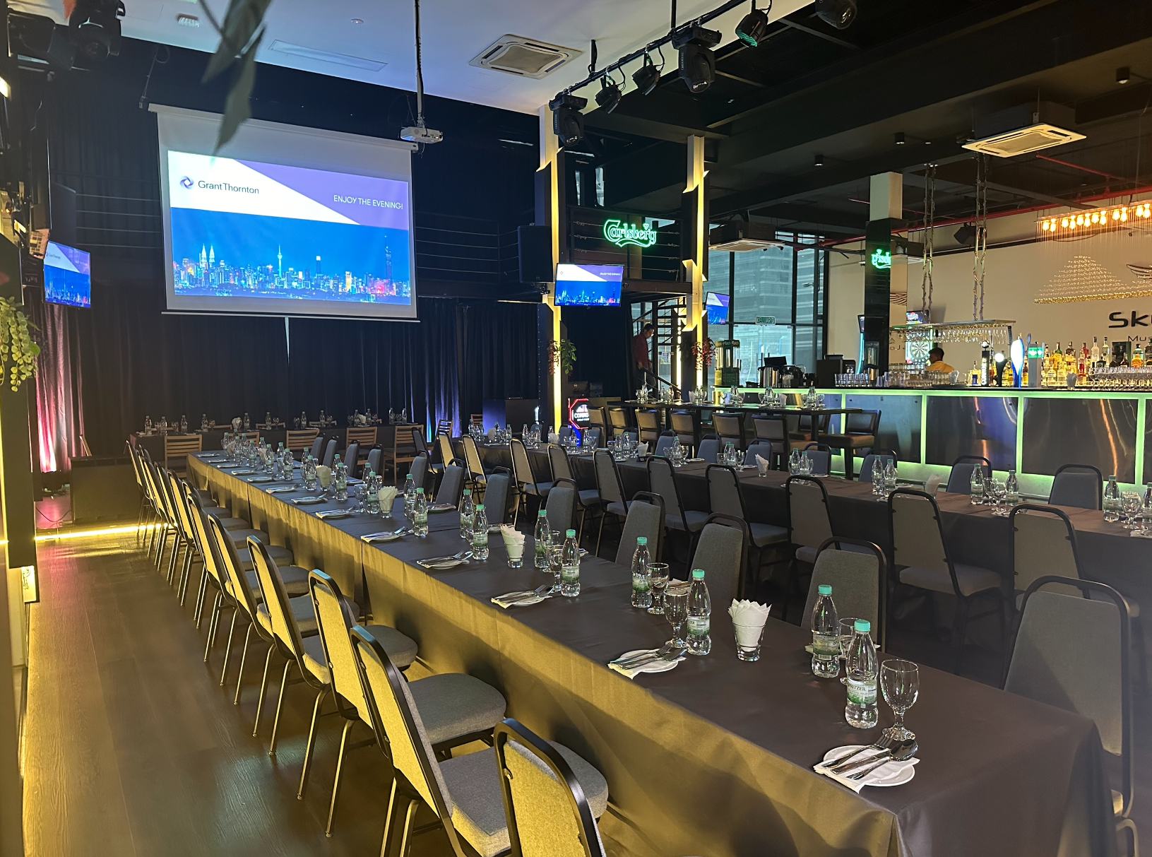 Corporate event set up in the glasshouse with a large screen